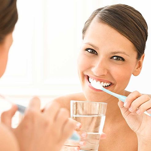 Woman brushing her teeth