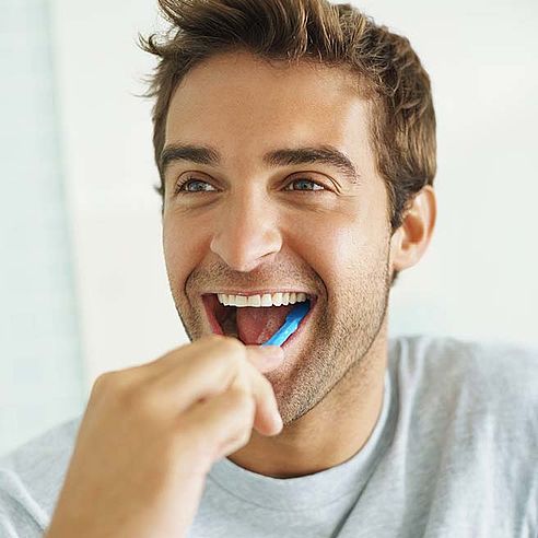 Young man brushing his teeth